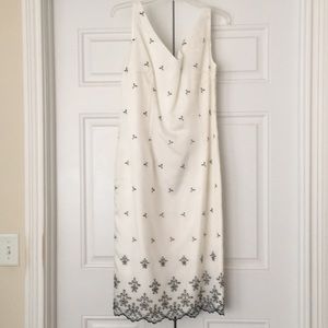 White satiny sheath with embroidered overlay